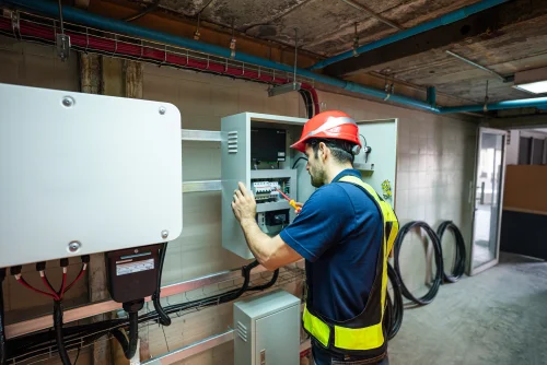 Technician working on energy storage control panel